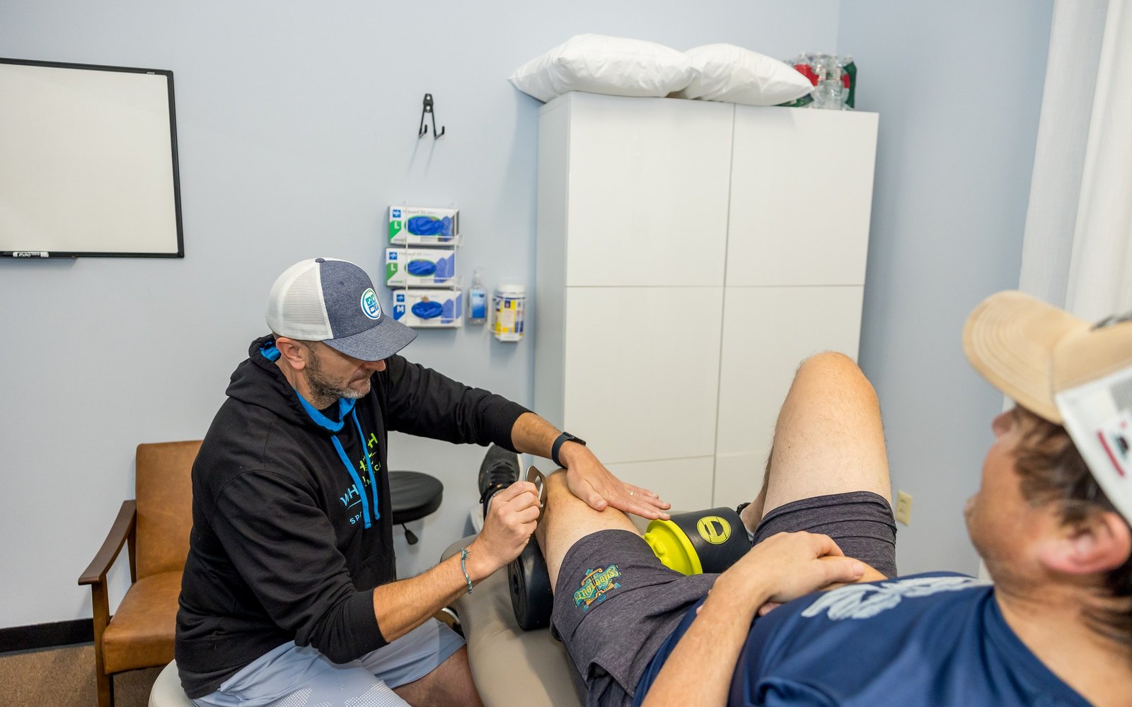 Physical therapist treating a client's knee at Whole Health Solutions