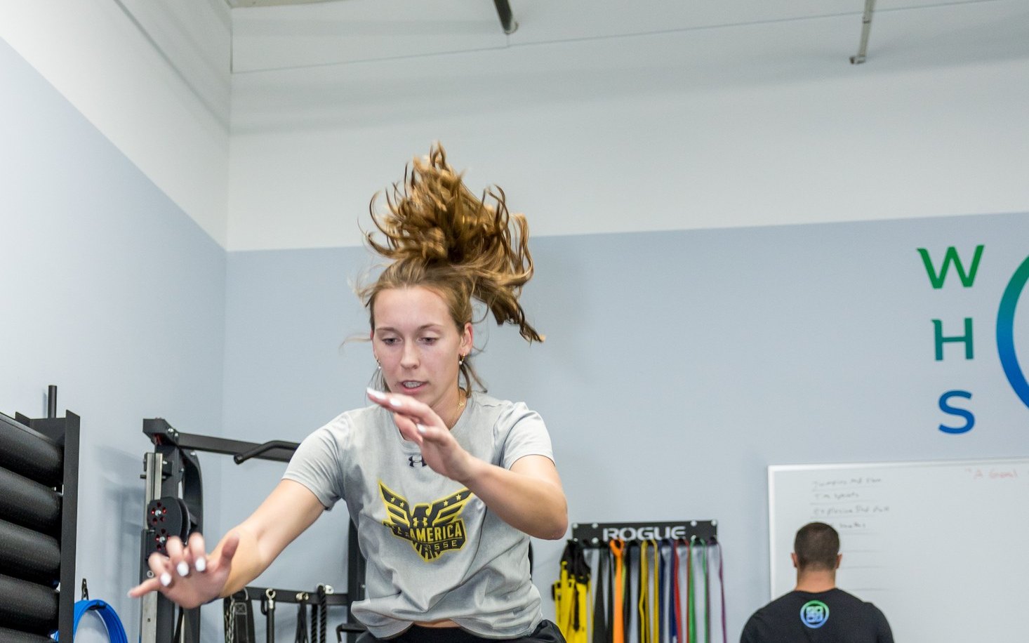 Young athlete doing a box jump in the WHS training center