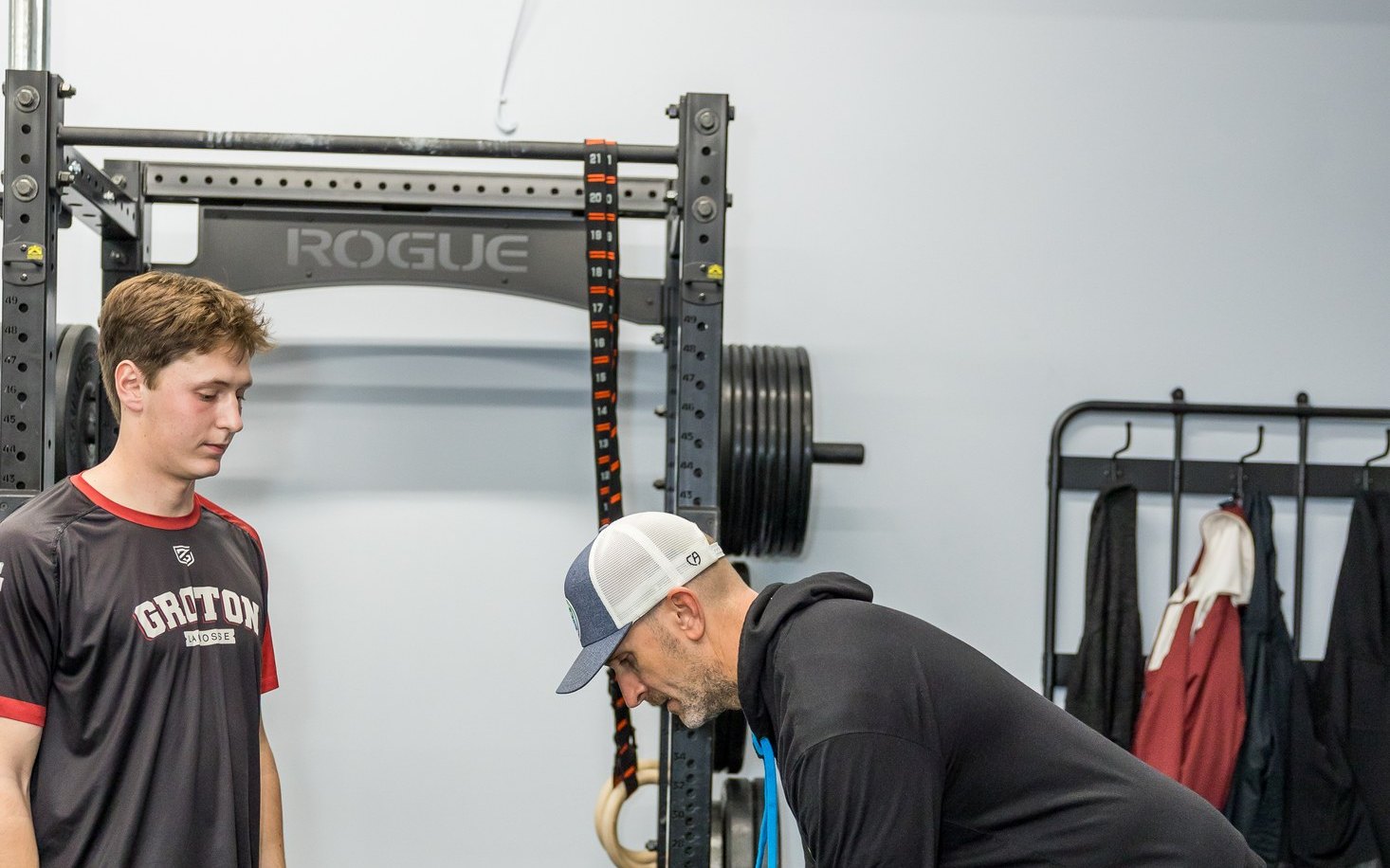 Coach assessing a young athlete before a training session