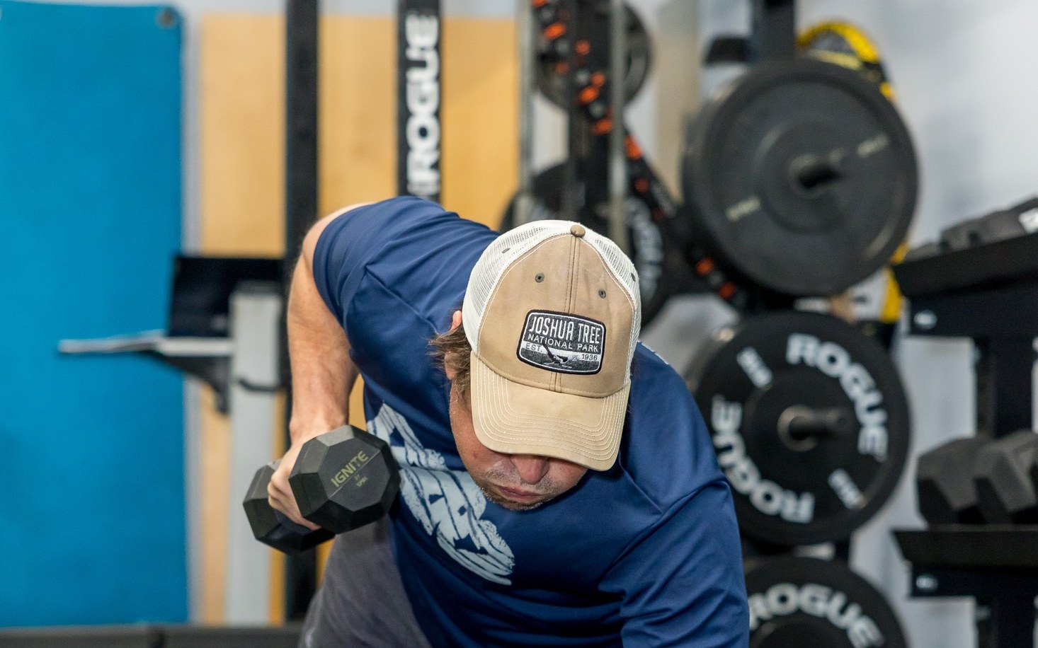 Client doing a dumbbell row during a strength session