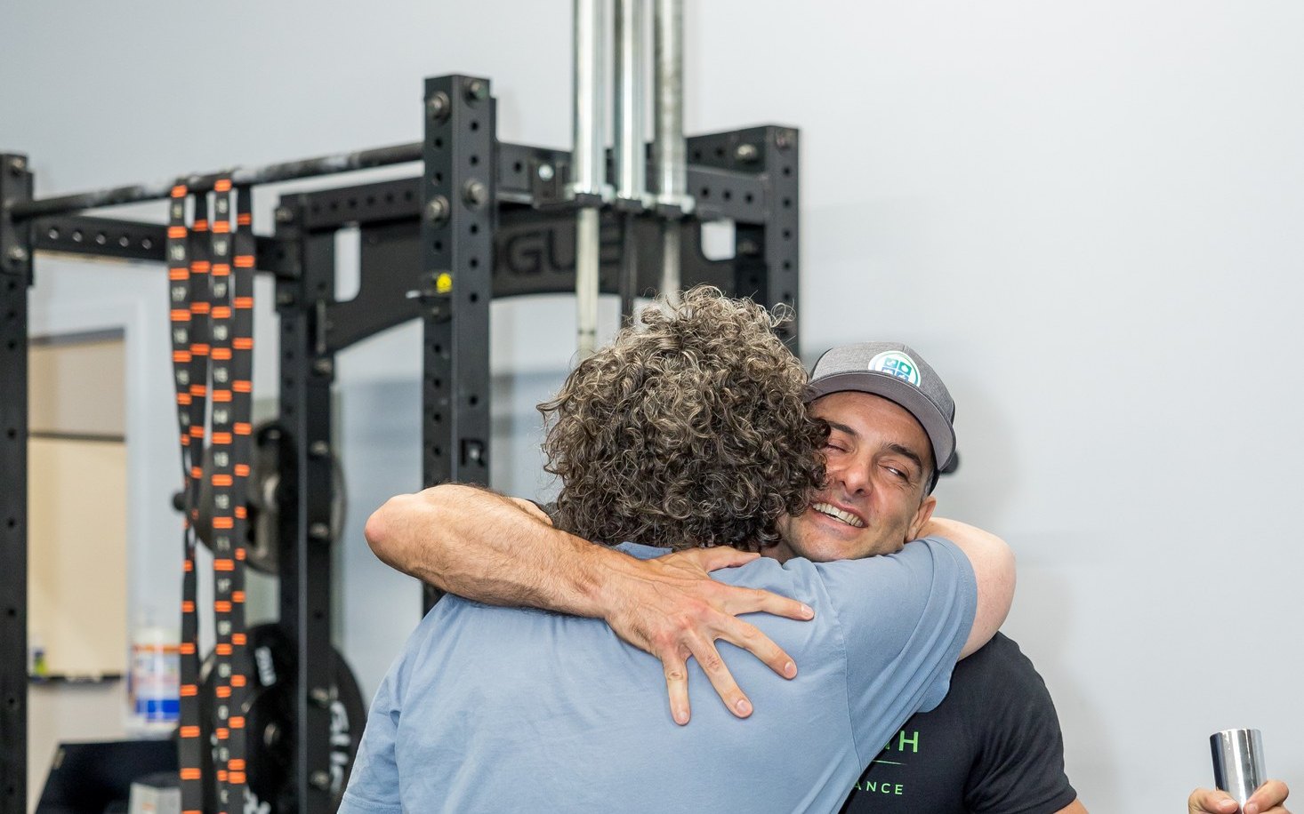 Client hugging her coach in the WHS training center