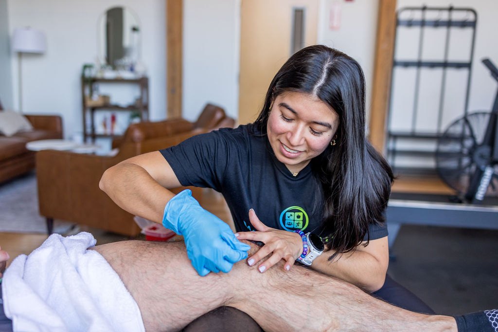 A physical therapist treating a client's knee at Whole Health Solutions