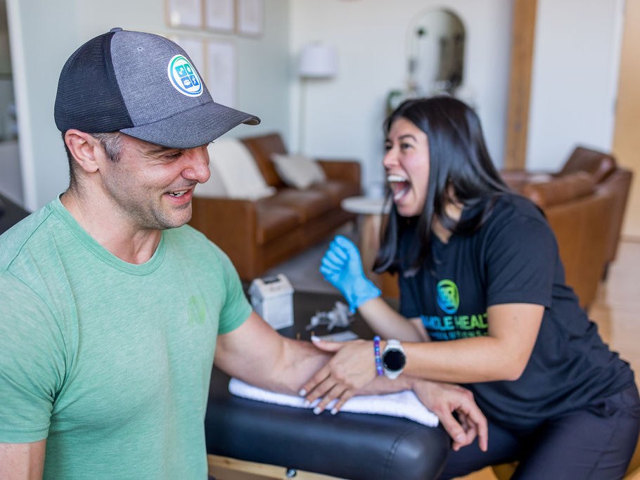 A physical therapist treating a tight muscle with dry needling