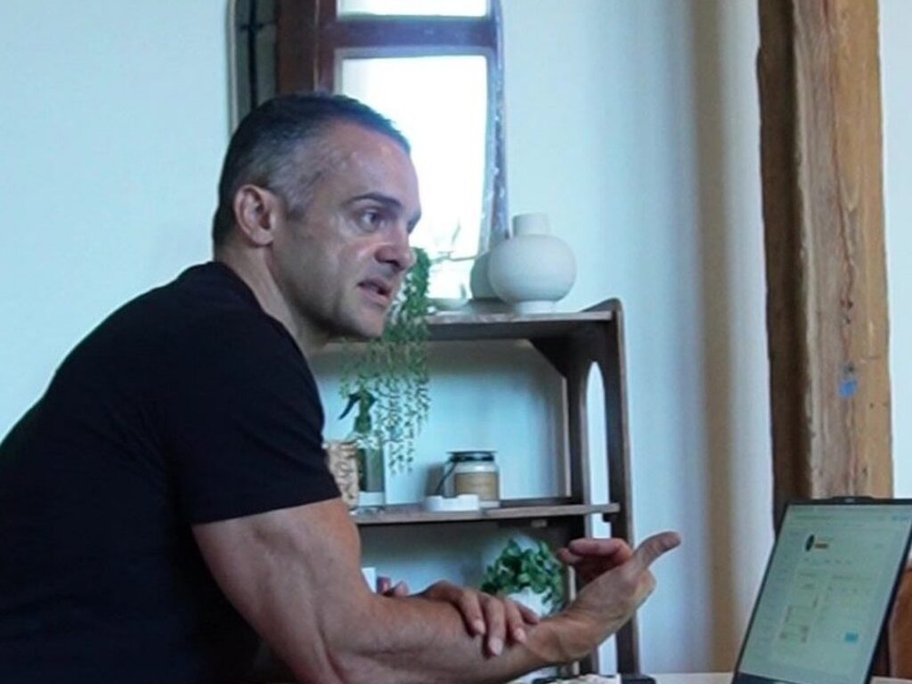 Health coach walking a client through a habit plan on a laptop