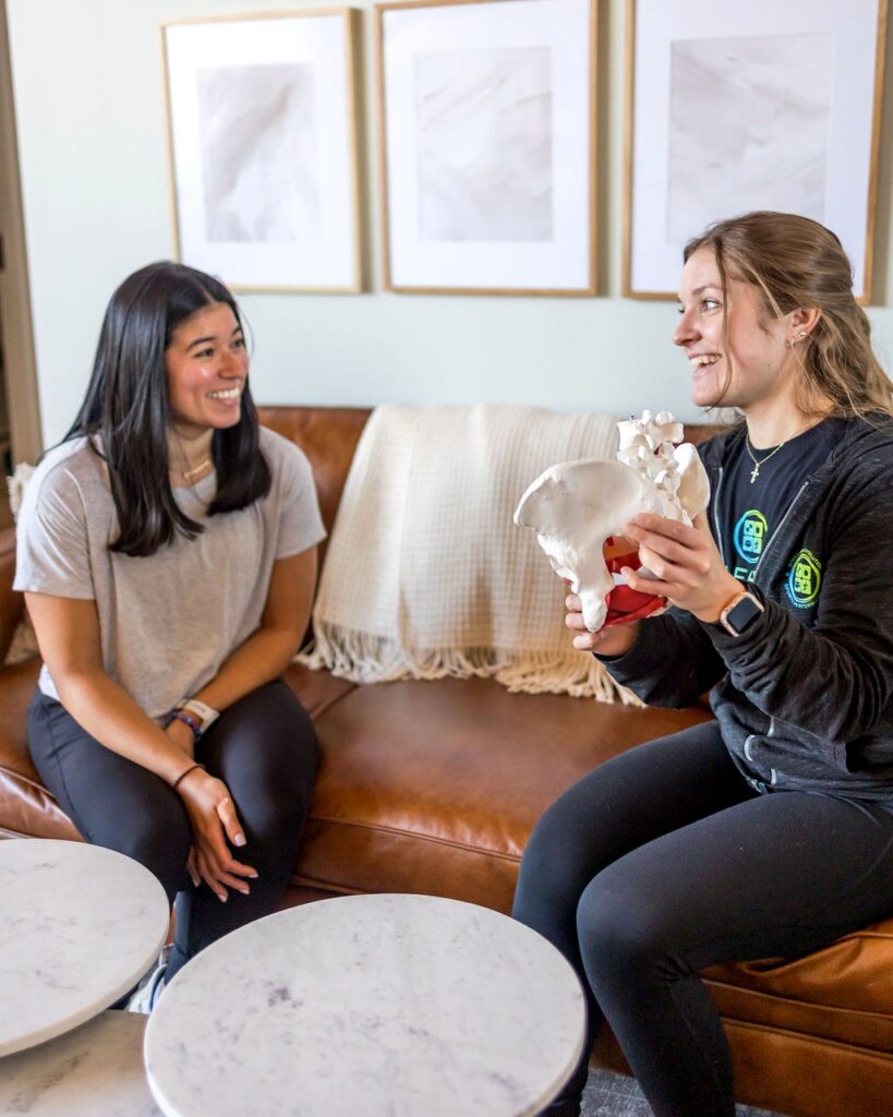 A pelvic floor physical therapist talking with a client in the private Pelvic Health Center room