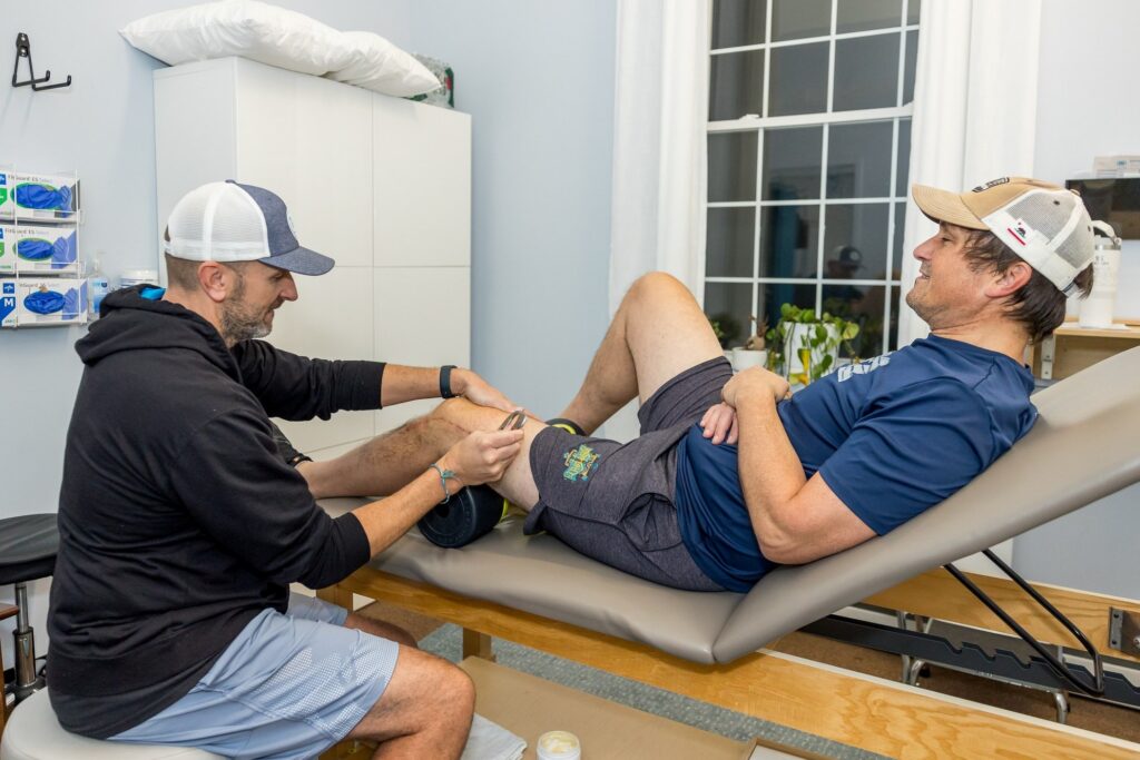 Physical therapist working on a client's knee at Whole Health Solutions in Shirley, MA