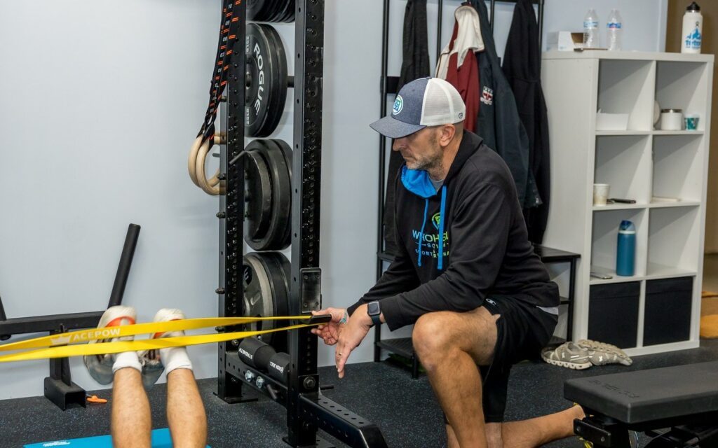 A physical therapist guiding a client through rehab after surgery