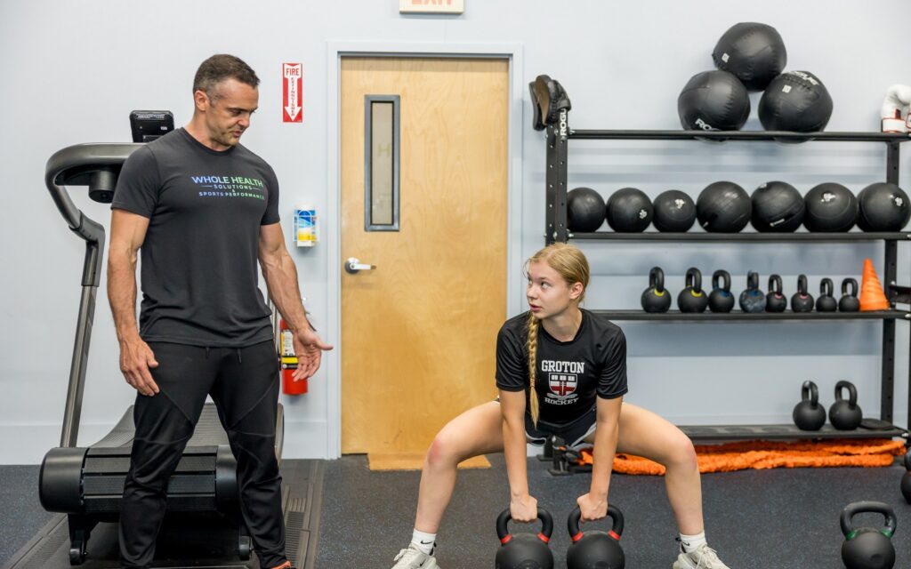 A physical therapist working with an athlete at Whole Health Solutions