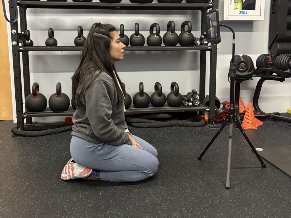 A client following her coach live by video during a virtual session