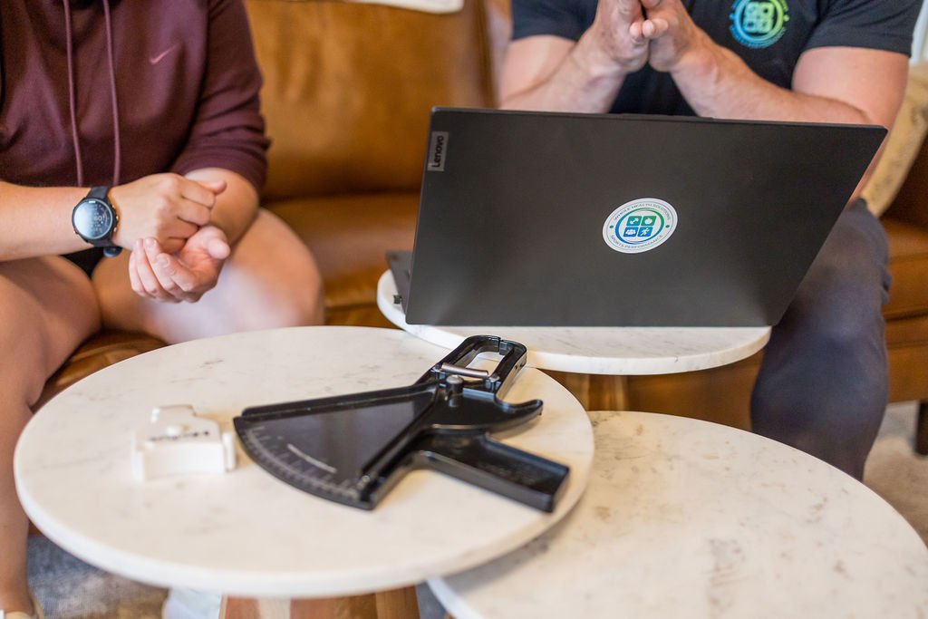 Body composition calipers and a laptop during a health coaching check in
