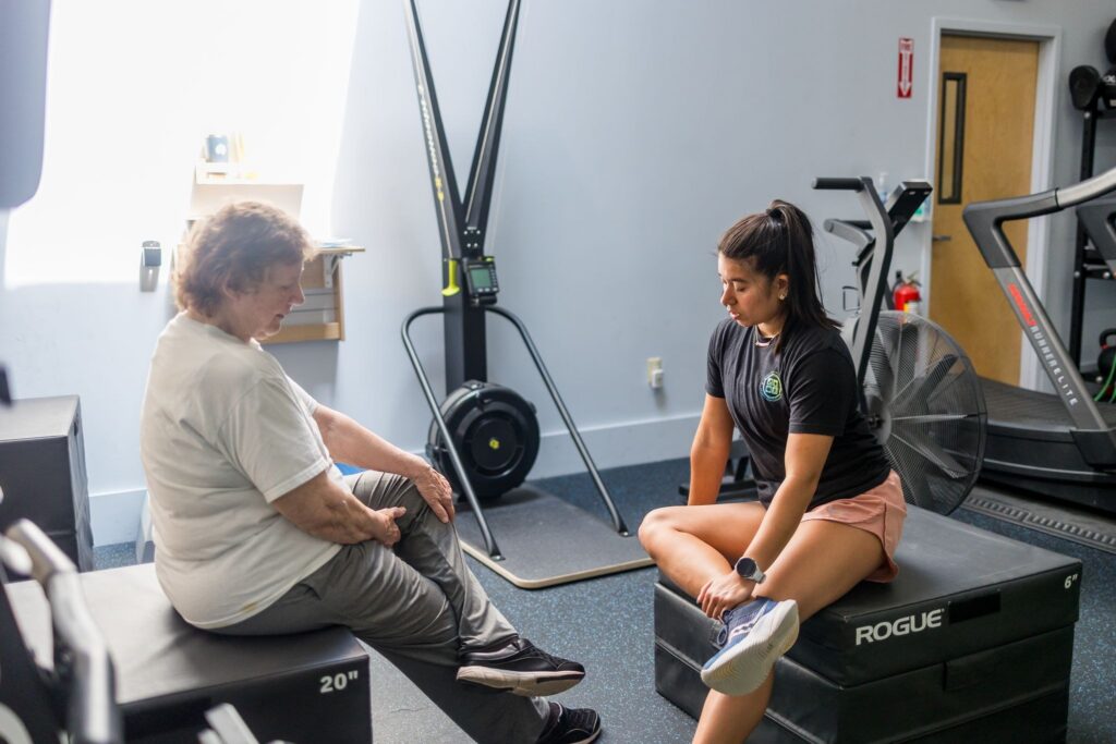 Physical therapist talking through a plan with a client in the WHS clinic