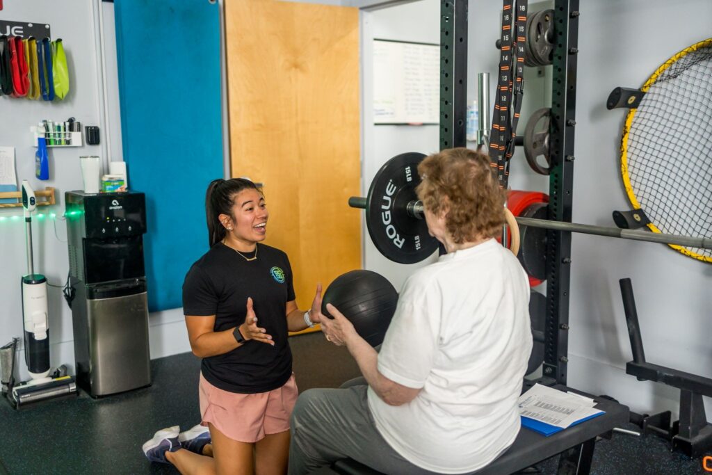 Physical therapist working with an older client in the WHS clinic